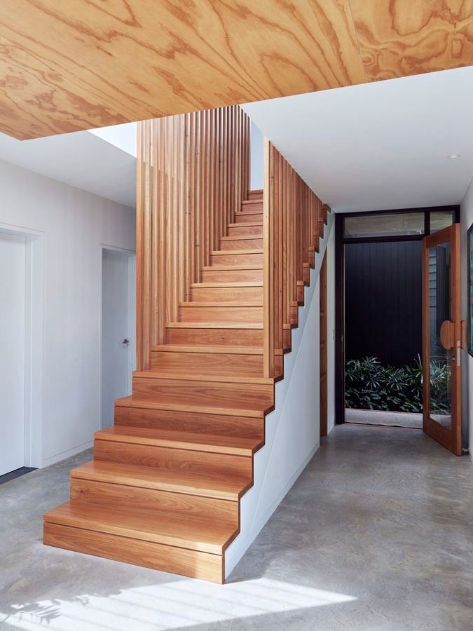 Modern Wooden Staircase in A Bright Hallway with Concrete Floor and Glass Doors to A Garden — Fineworx Joinery in Warnervale, NSW