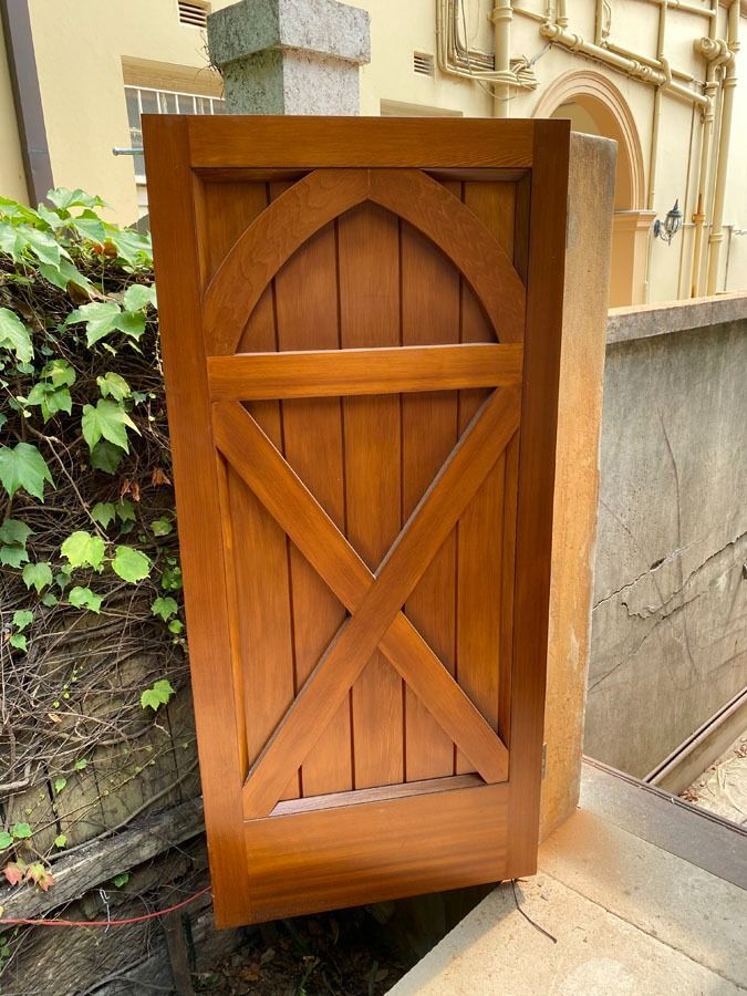 Wooden Gate Door with Diagonal Cross Braces Open Beside a Stone Wall — Fineworx Joinery in Warnervale, NSW