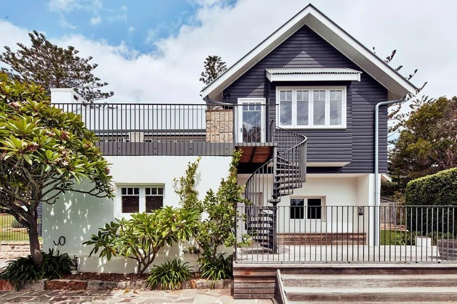 Modern Two Story House with Gray Siding and Front Steps Behind a White Wall — Fineworx Joinery in Warnervale, NSW