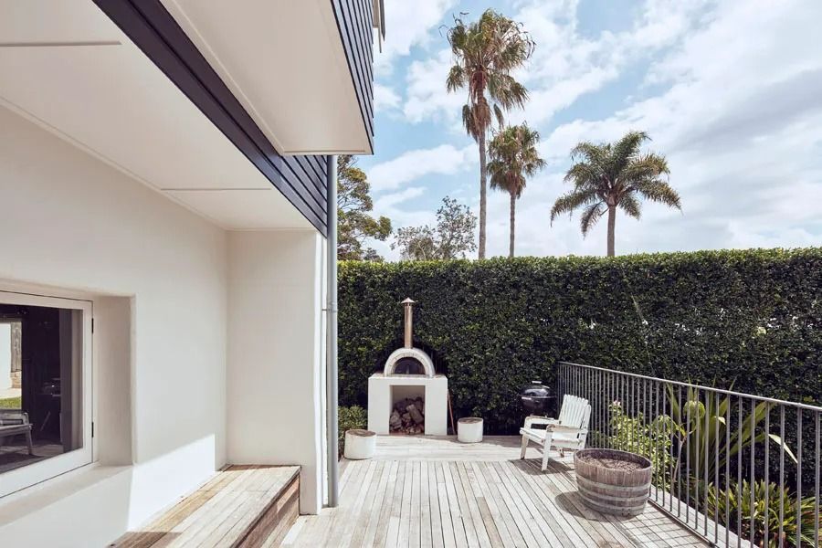 Modern Patio with White Furniture and Furnace and a Hedge Privacy Wall — Fineworx Joinery in Warnervale, NSW