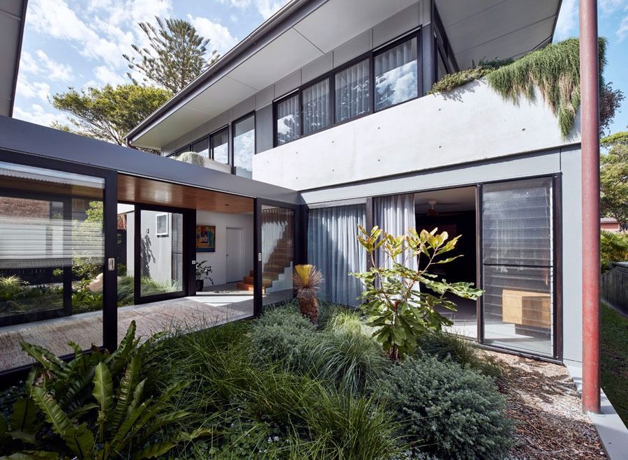 Modern Two Story House with A Landscaped Courtyard and Large Glass Windows — Fineworx Joinery in Warnervale, NSW
