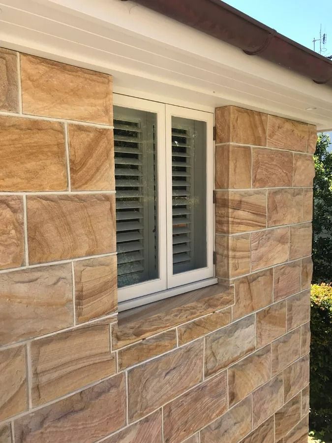 Stone Exterior Wall with A White Framed Window and Closed Gray Shutters — Fineworx Joinery in Warnervale, NSW