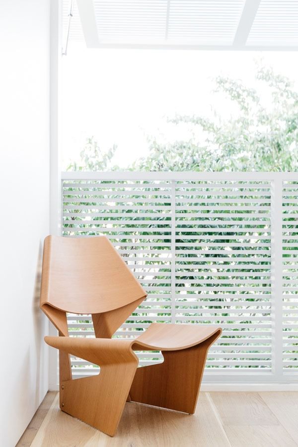 Modern Wooden Chair and Stool Beside a Bright Window with White Blinds — Fineworx Joinery in Warnervale, NSW