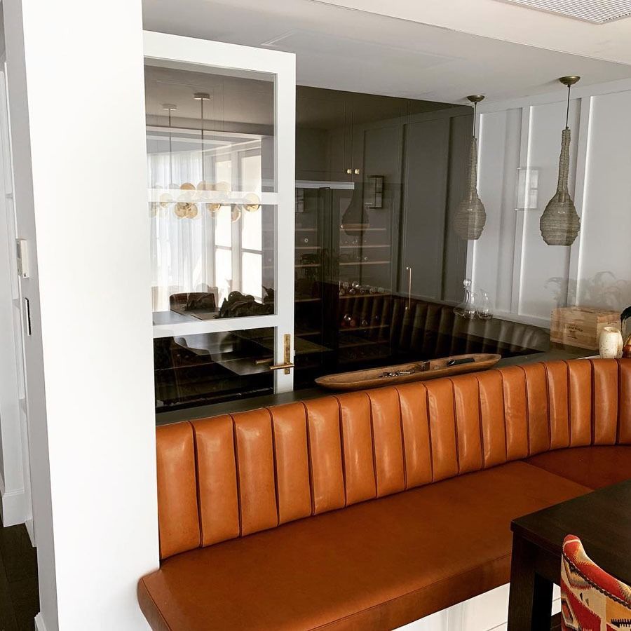 Orange Leather Banquette in A Modern Dining Space with Dark Tables and Pendant Lights — Fineworx Joinery in Warnervale, NSW