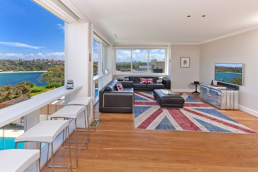 Bright Living Room with Ocean Views and White Stools by Large Windows — Fineworx Joinery in Warnervale, NSW