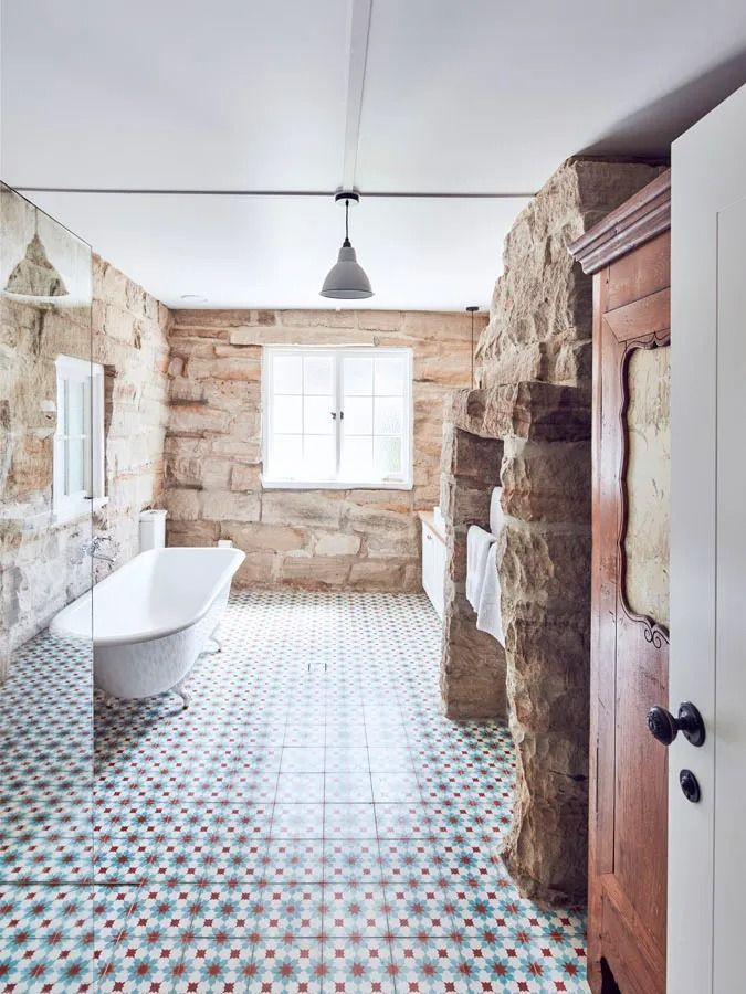 Stone Bathroom with Freestanding Tub and Patterned Tile Floor and A Window — Fineworx Joinery in Warnervale, NSW