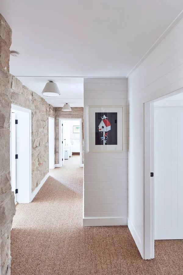 Narrow Hallway with White Walls, Stone Accent Wall and Framed Artwork — Fineworx Joinery in Warnervale, NSW