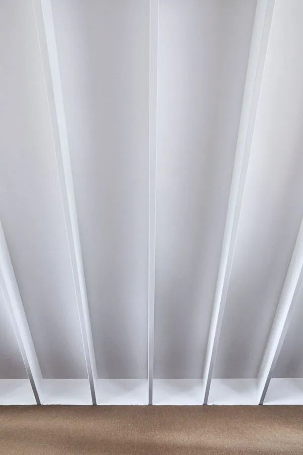 Close Up of White Vertical Blinds with Light Filtering Through Them — Fineworx Joinery in Warnervale, NSW