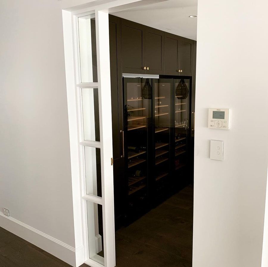 Interior Doorway with Dark Built In Cabinets Visible Through a White Door Frame — Fineworx Joinery in Warnervale, NSW