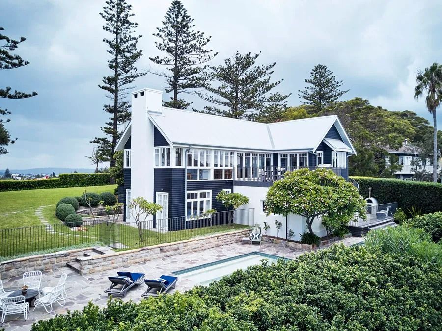 White Two Story Seaside House with A Blue Roof — Fineworx Joinery in Warnervale, NSW