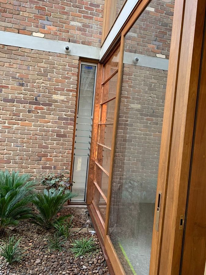 Brick Courtyard with A Wooden Framed Glass Door — Fineworx Joinery in Warnervale, NSW