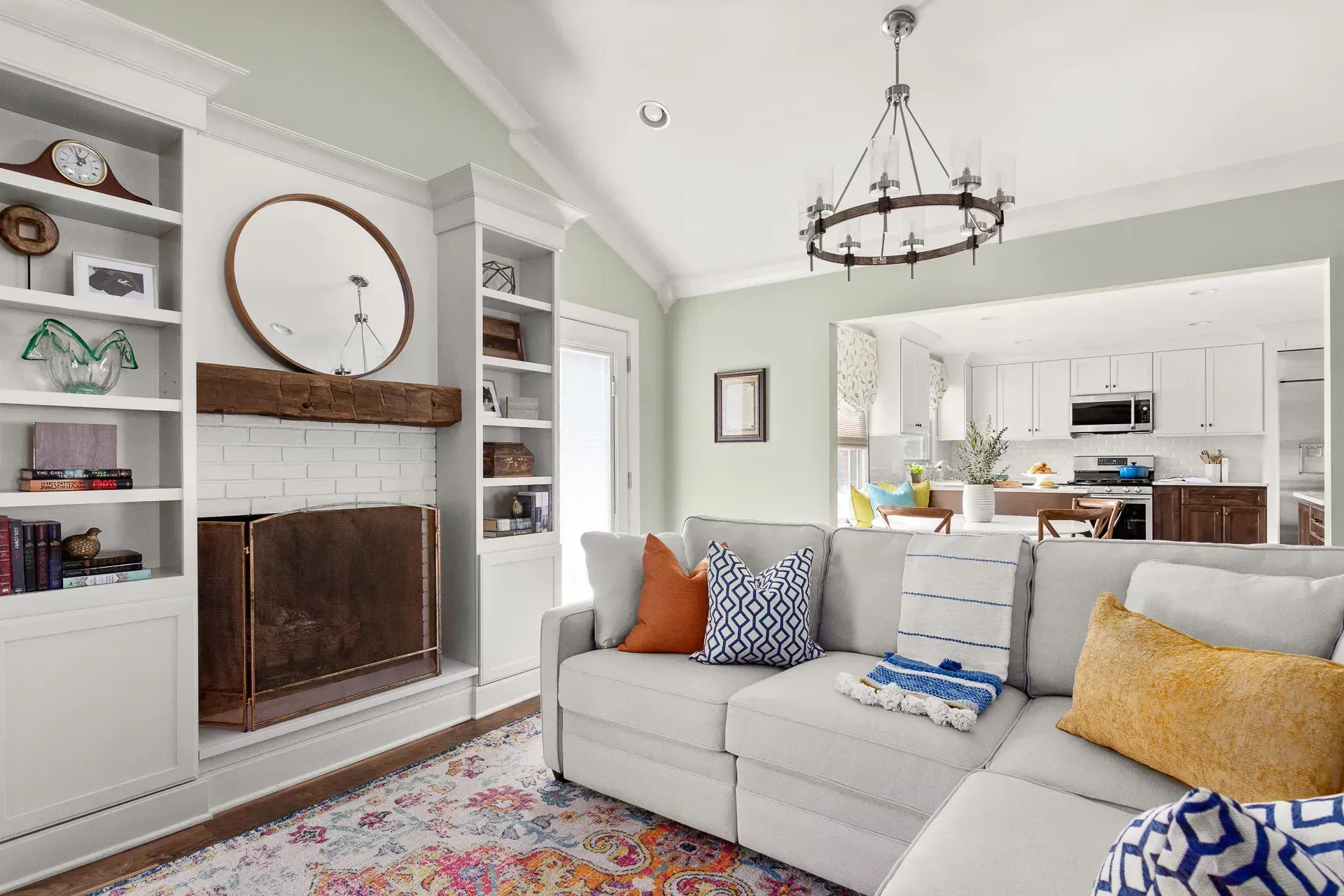 A living room with a fireplace. There's a couch that looks uncomfortable.