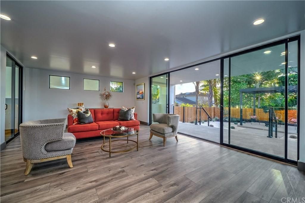 A living room with a red couch and large sliding doors to a patio.