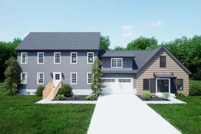 Two-story gray house beside a tan garage, with a white driveway and green lawn.