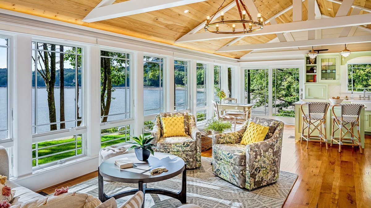 A nice enclosed porch with furniture