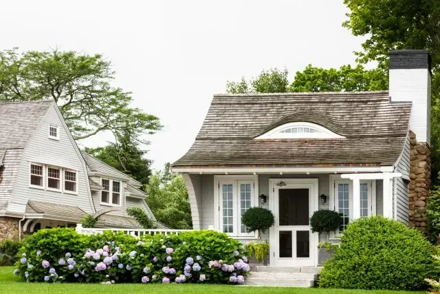 A small white house with a thatched roof