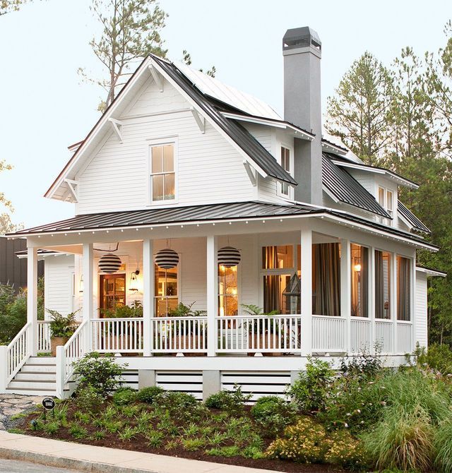 A white house with a large porch and a chimney