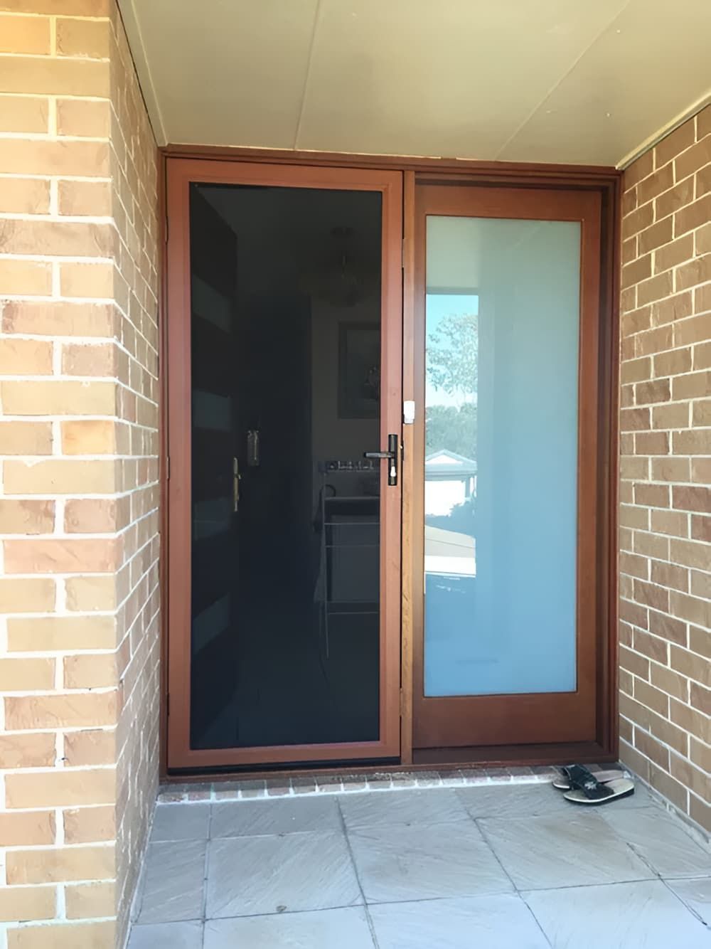 A Brick Building With A Sliding Glass Door And A Screen Door — Screen Factory In Ocean Shores, NSW