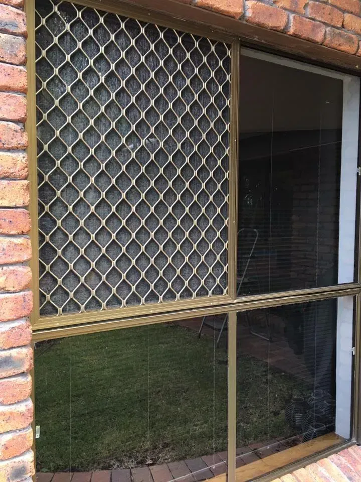 A Brick Building With A Window With A Screen On It — Screen Factory In Ocean Shores, NSW