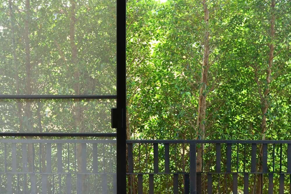 A Screened In Porch With Trees In The Background — Screen Factory In Ocean Shores, NSW