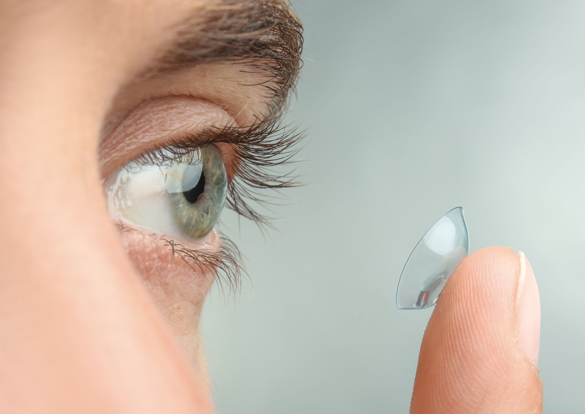 Close-up of a person inserting a prescribed contact lens near Mawson Lakes SA.