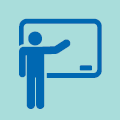 Blue figure of a person standing, gesturing to a whiteboard.