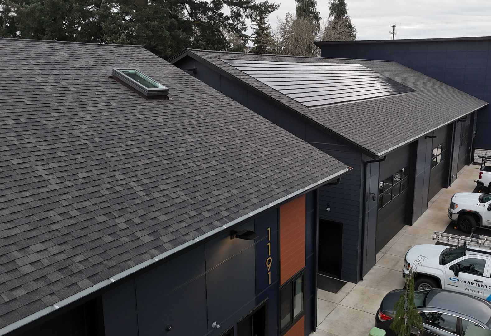 The side of a home with shingles roofing.