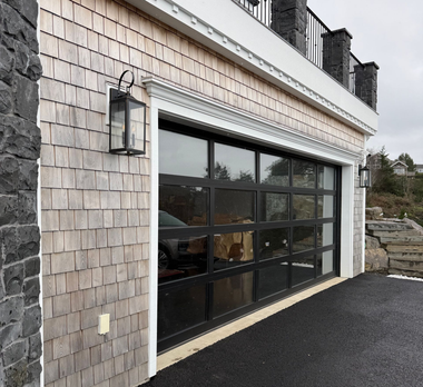 A brick house with a gray garage door