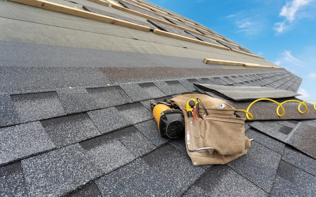 Professional roofing installation tools laid on a roof.