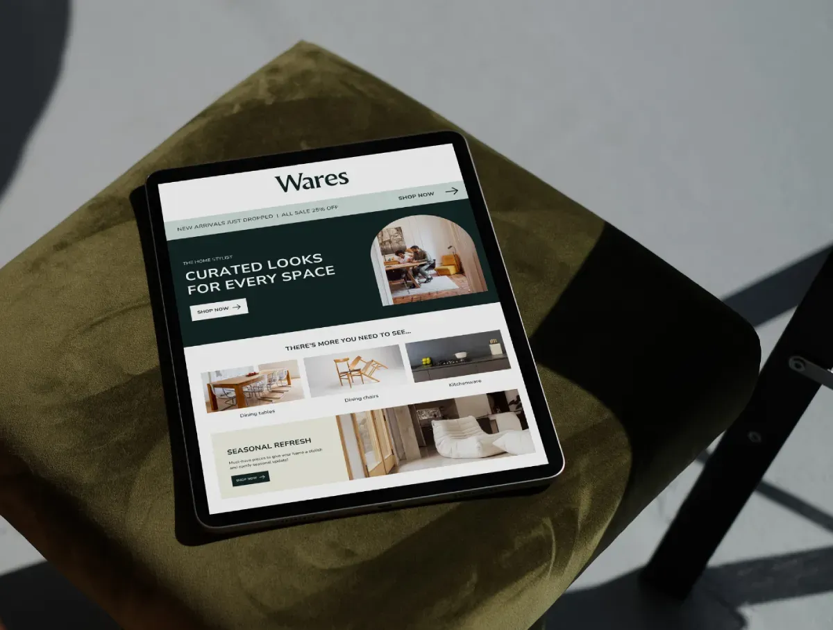 Tablet displaying a shopping website on a green cushioned chair
