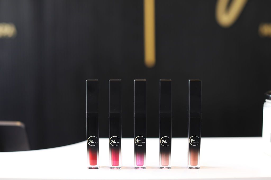 A row of lipsticks are lined up on a table