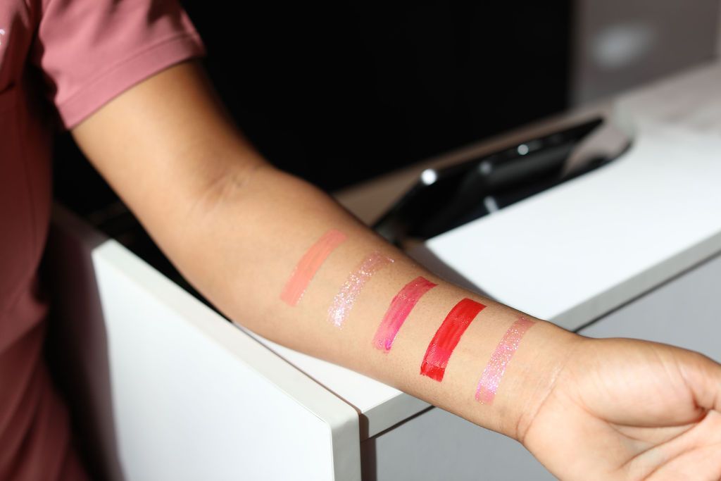 A woman 's arm with lipstick samples on it