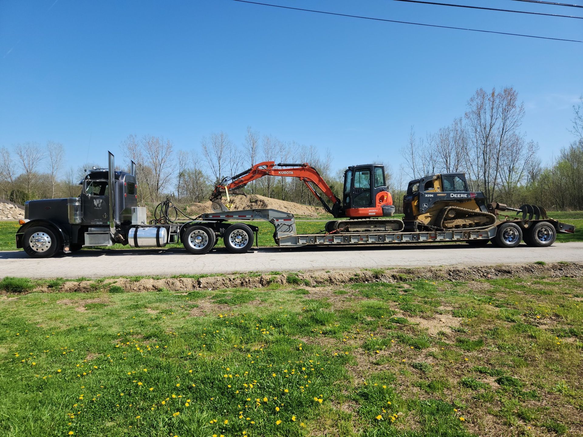 A Semi Truck Is Carrying A Bulldozer On A Trailer — Atwater, OH — Werab Enterprises