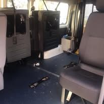 A woman in a wheelchair is getting out of a van