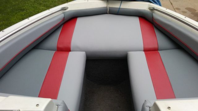A boat with a red and gray stripe on the seats