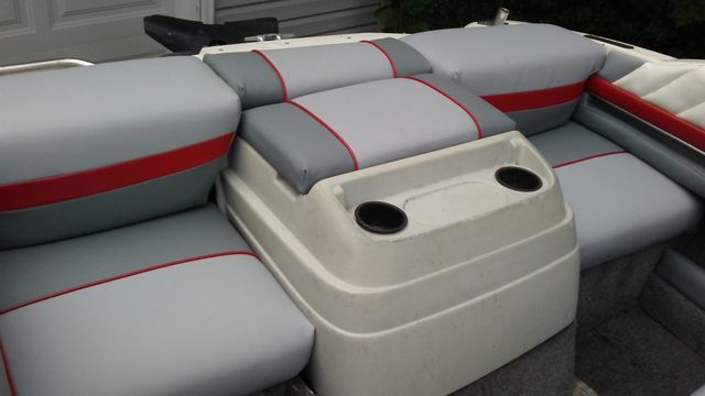 The inside of a boat with tan and white seats
