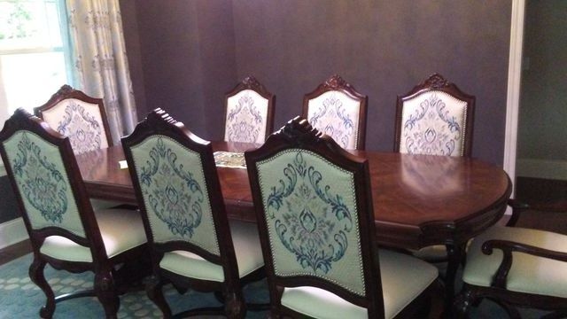 A dining room with a table and chairs in it