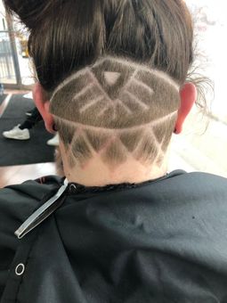 A woman with a shaved design on the back of her head.