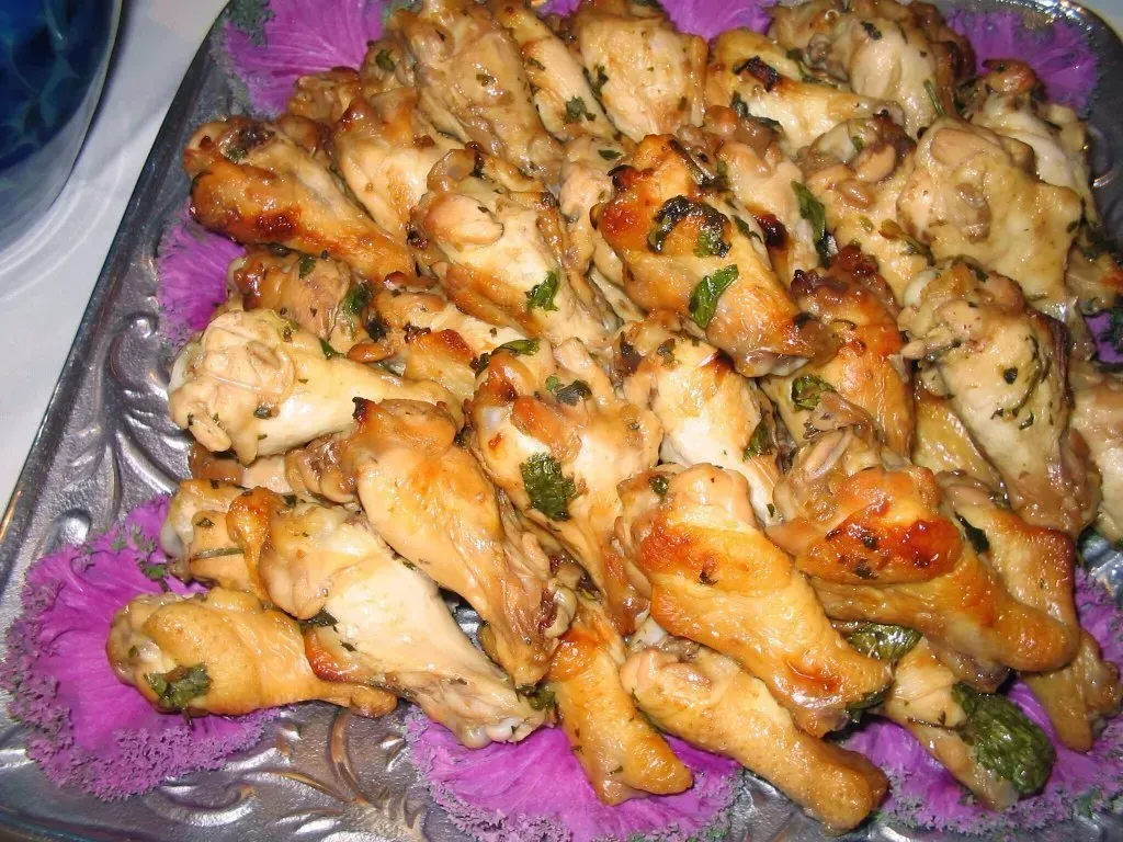 A plate of food with chicken and vegetables on a table. A plate of food with chicken and vegetables on a table.