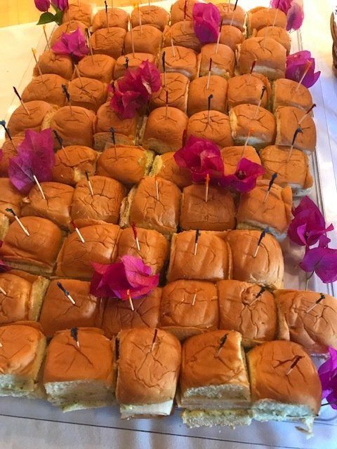 A bunch of sandwiches with flowers on them on a table