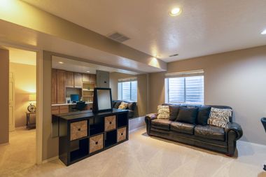 Modern living room with dark sofa, cube storage console, and recessed ceiling lights