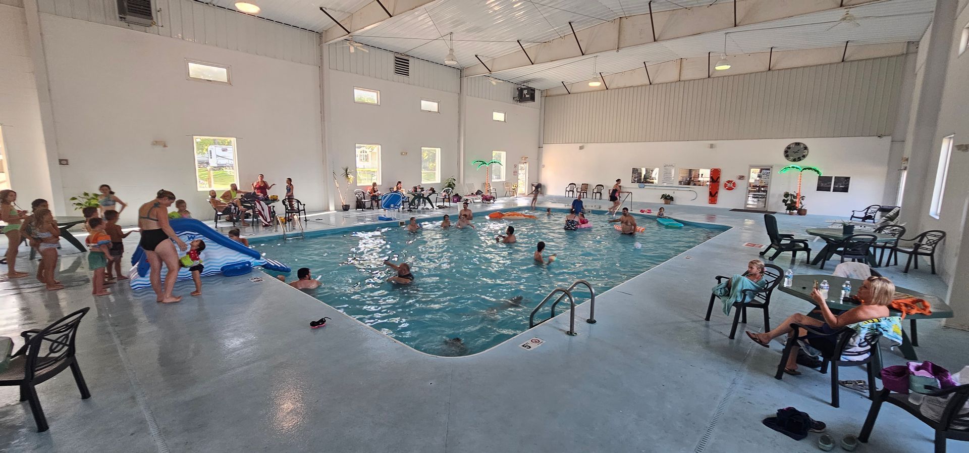 people are playing in a large indoor swimming pool