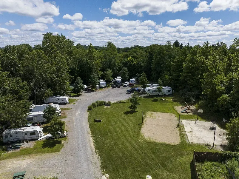 an aerial view of a campground with a volleyball court