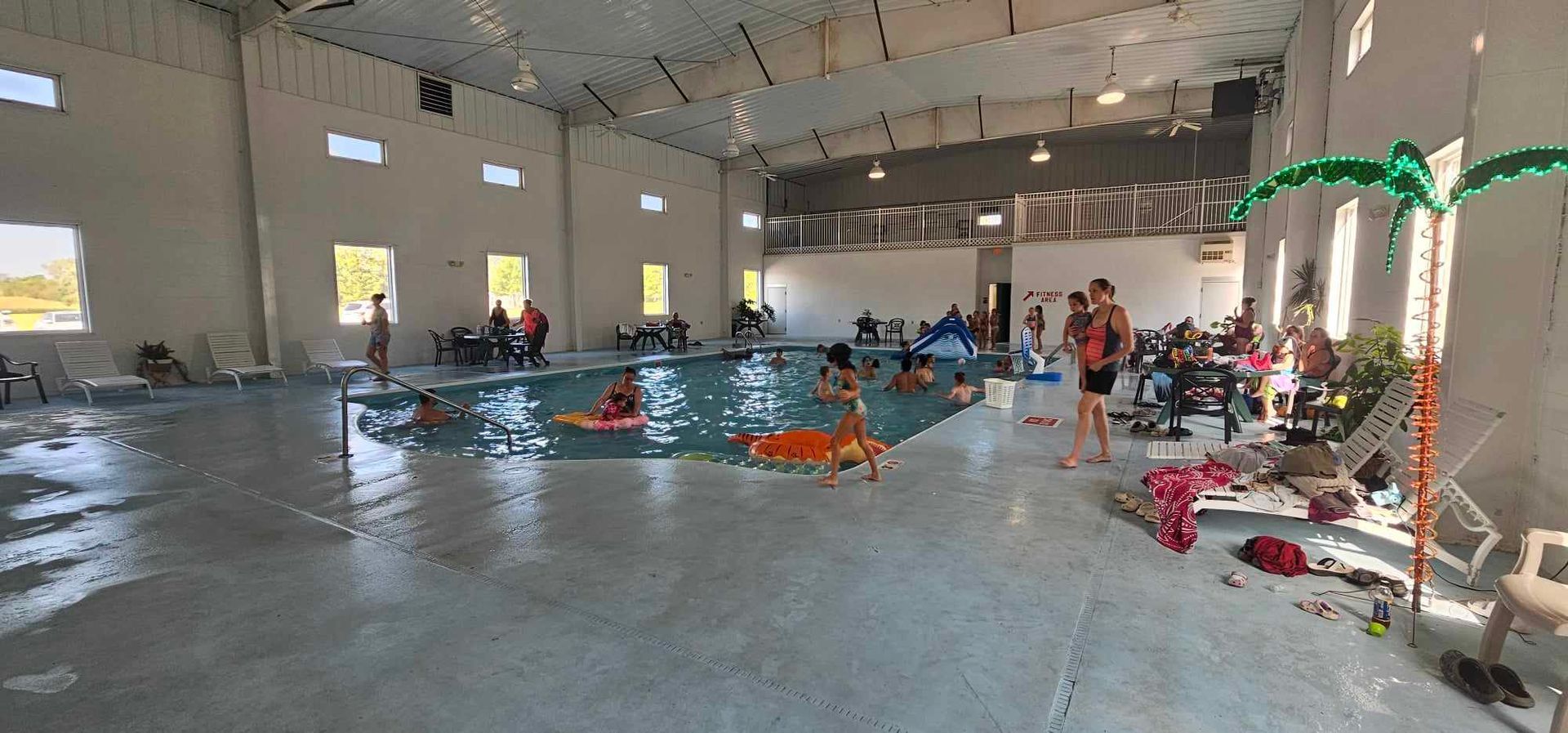a group of people are playing in an indoor swimming pool