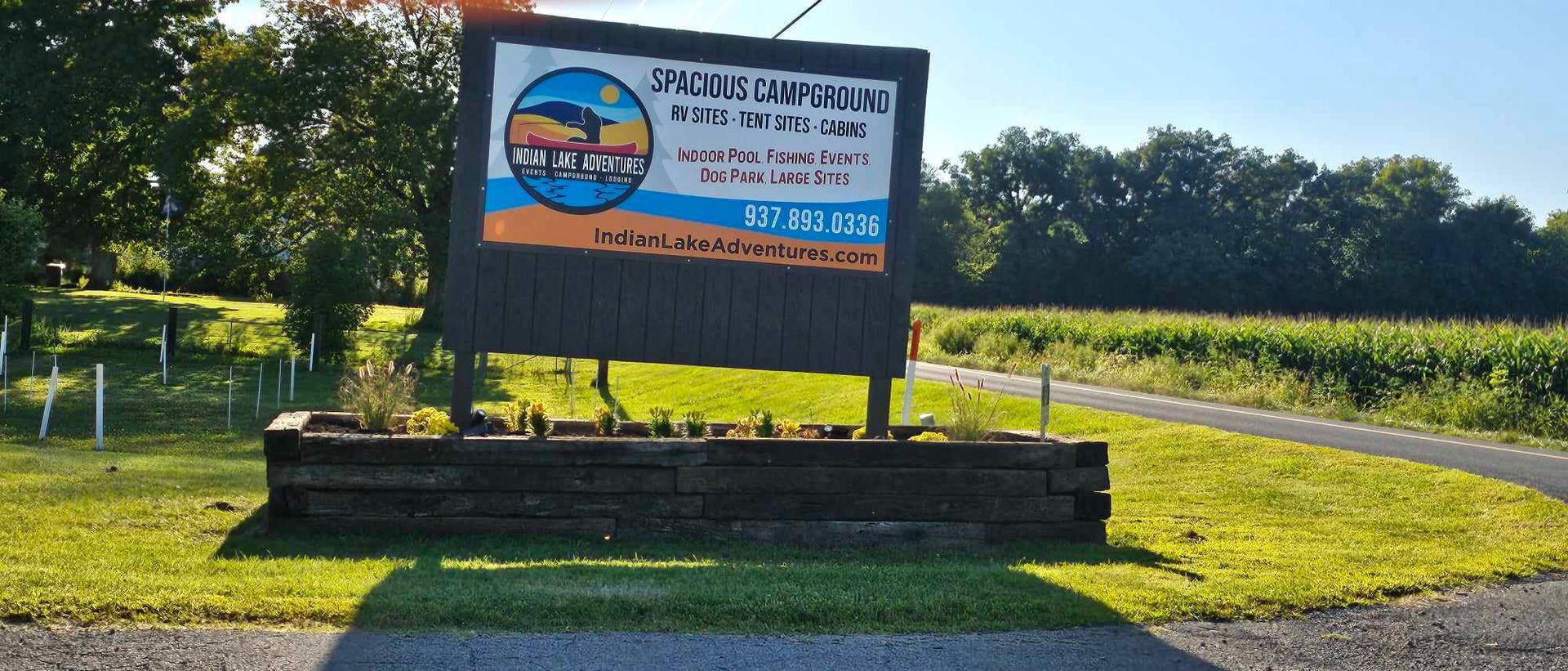 a sign for spacious campground in indian lake adventures