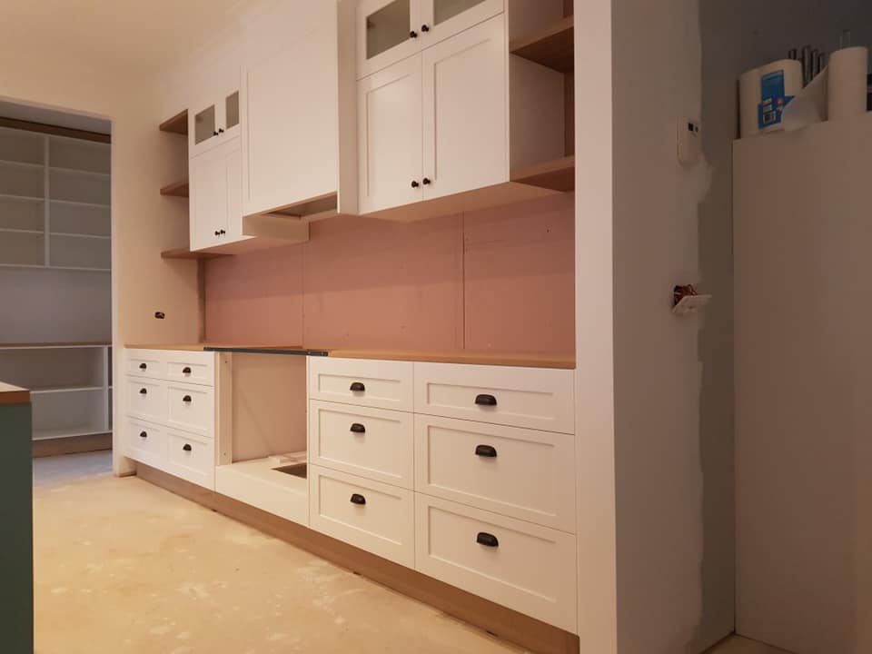 Woman Unpacking Flatpack Kitchen Cupboards - Melbourne - Universal Timbers