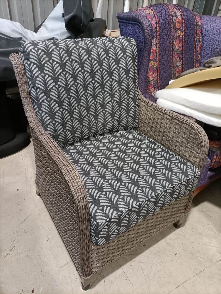 A Wicker Chair With A Patterned Cushion Is Sitting In A Room — Ocean Charm Upholstery In Southport, QLD