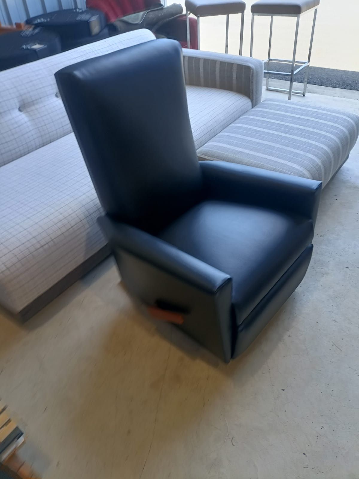 A Black Leather Chair Is Sitting In A Living Room — Ocean Charm Upholstery In Southport, QLD