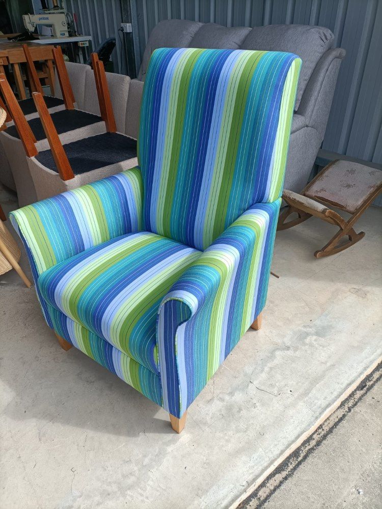 A Blue And Green Striped Chair Is Sitting On A Cement Floor — Ocean Charm Upholstery In Southport, QLD