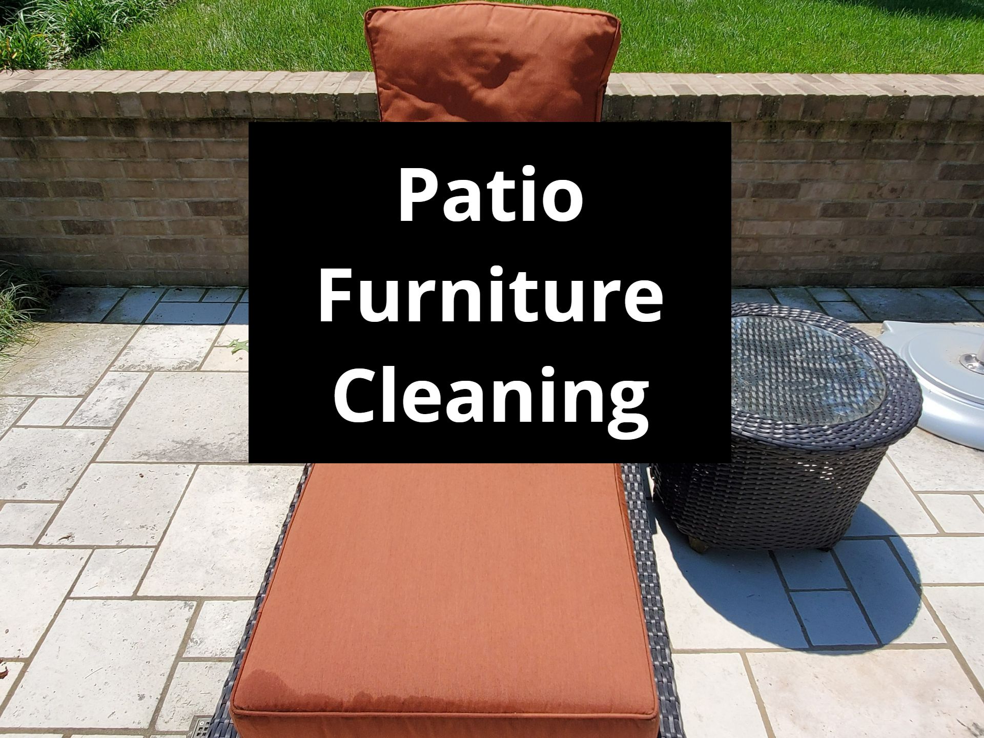 Patio furniture with orange cushions and a black wicker table on a stone patio; text overlay says